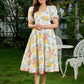 Luminous White Cotton Floral Dress with Square Neck, Contrasting Pink Accents, Flared Silhouette & Voluminous Puffy Sleeves