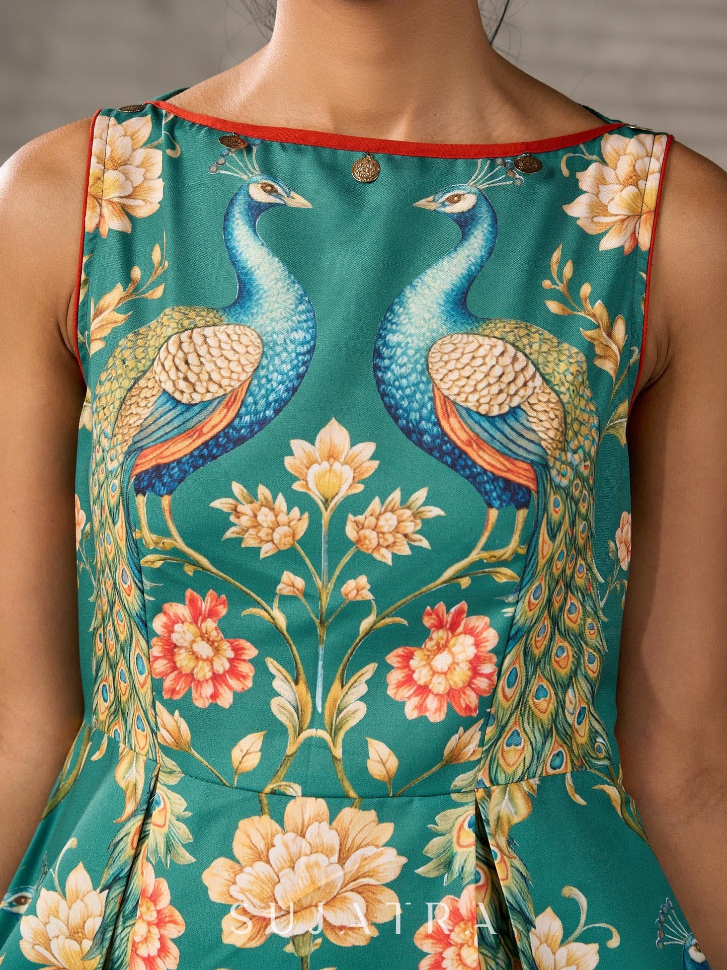 Green peacock motif printed dress with straight neckline and orange accents