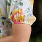 Luminous White Cotton Floral Dress with Square Neck, Contrasting Pink Accents, Flared Silhouette & Voluminous Puffy Sleeves