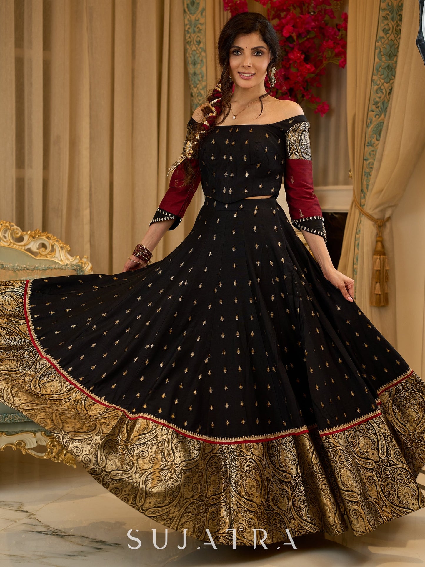 Black cotton silk & brocade lehenga paired with a sculpted corset style choli featuring intricate stonework on sleeves .