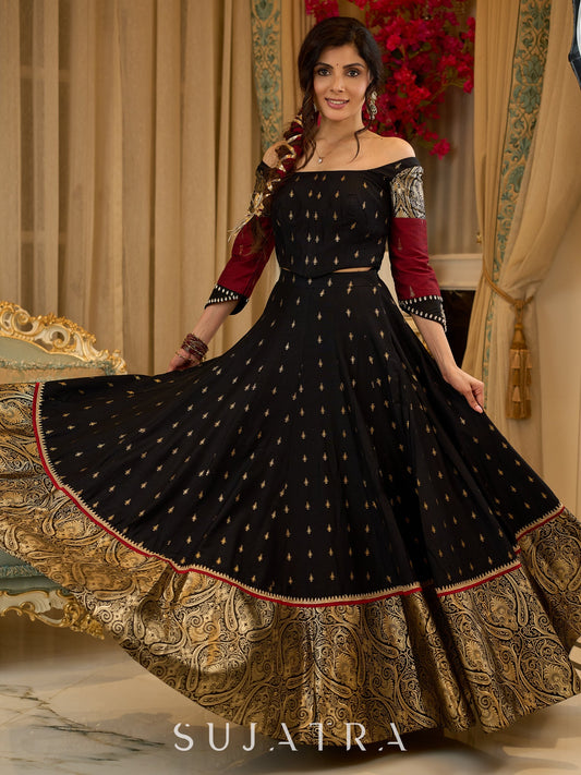 Black cotton silk & brocade lehenga paired with a sculpted corset style choli featuring intricate stonework on sleeves .