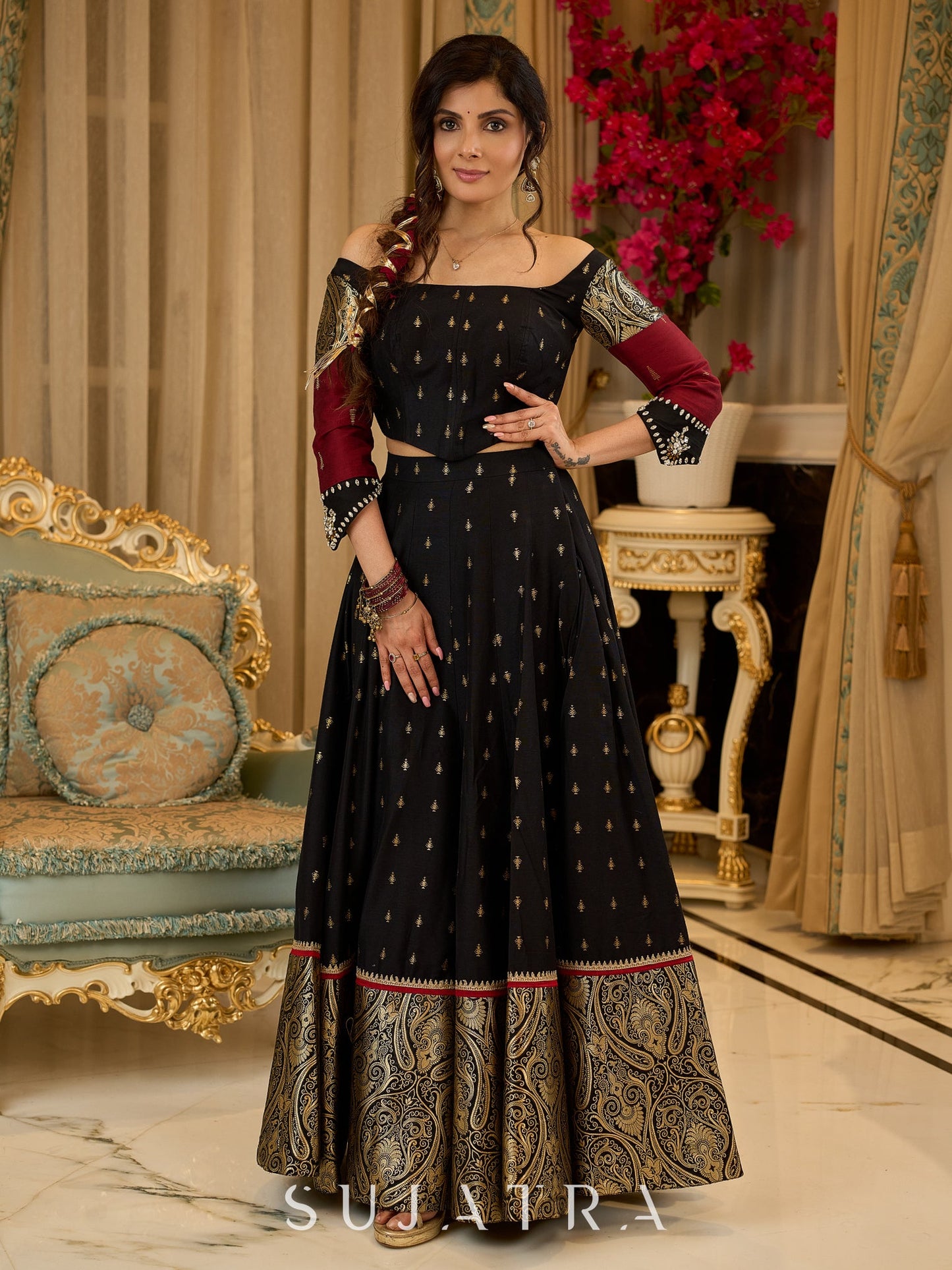 Black cotton silk & brocade lehenga paired with a sculpted corset style choli featuring intricate stonework on sleeves .