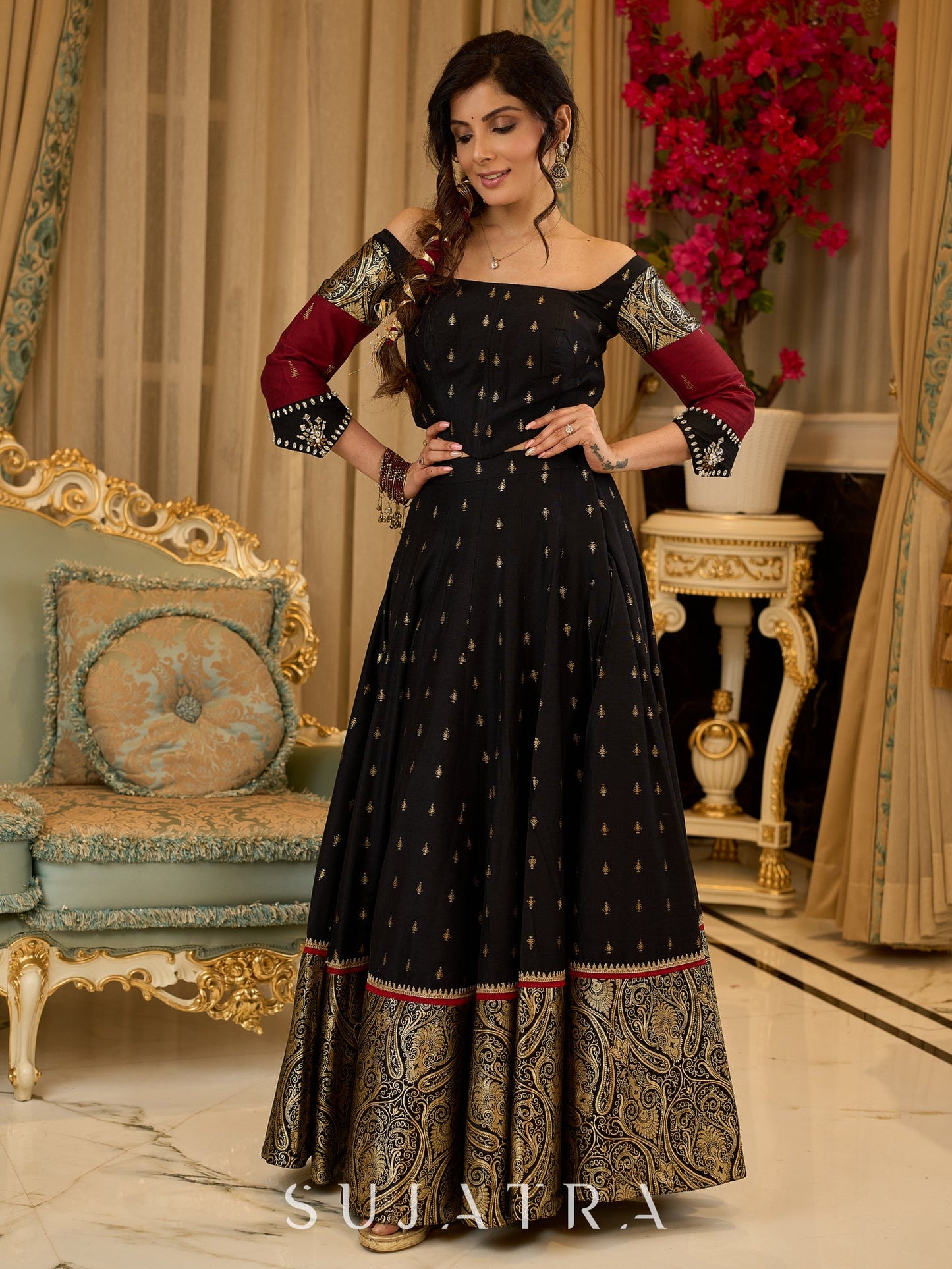 Black cotton silk & brocade lehenga paired with a sculpted corset style choli featuring intricate stonework on sleeves .