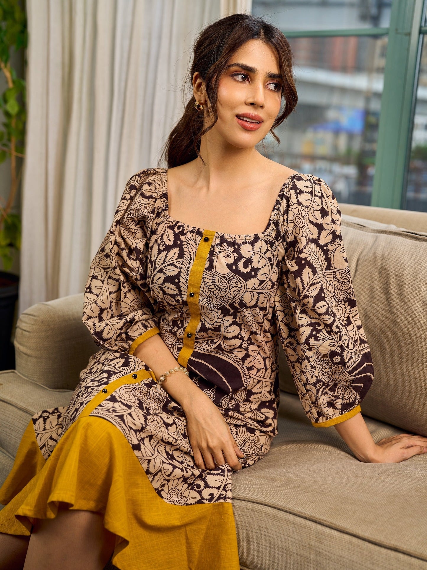 Heritage Kalamkari dress with elegant mustard accents and black pearl embellishments.