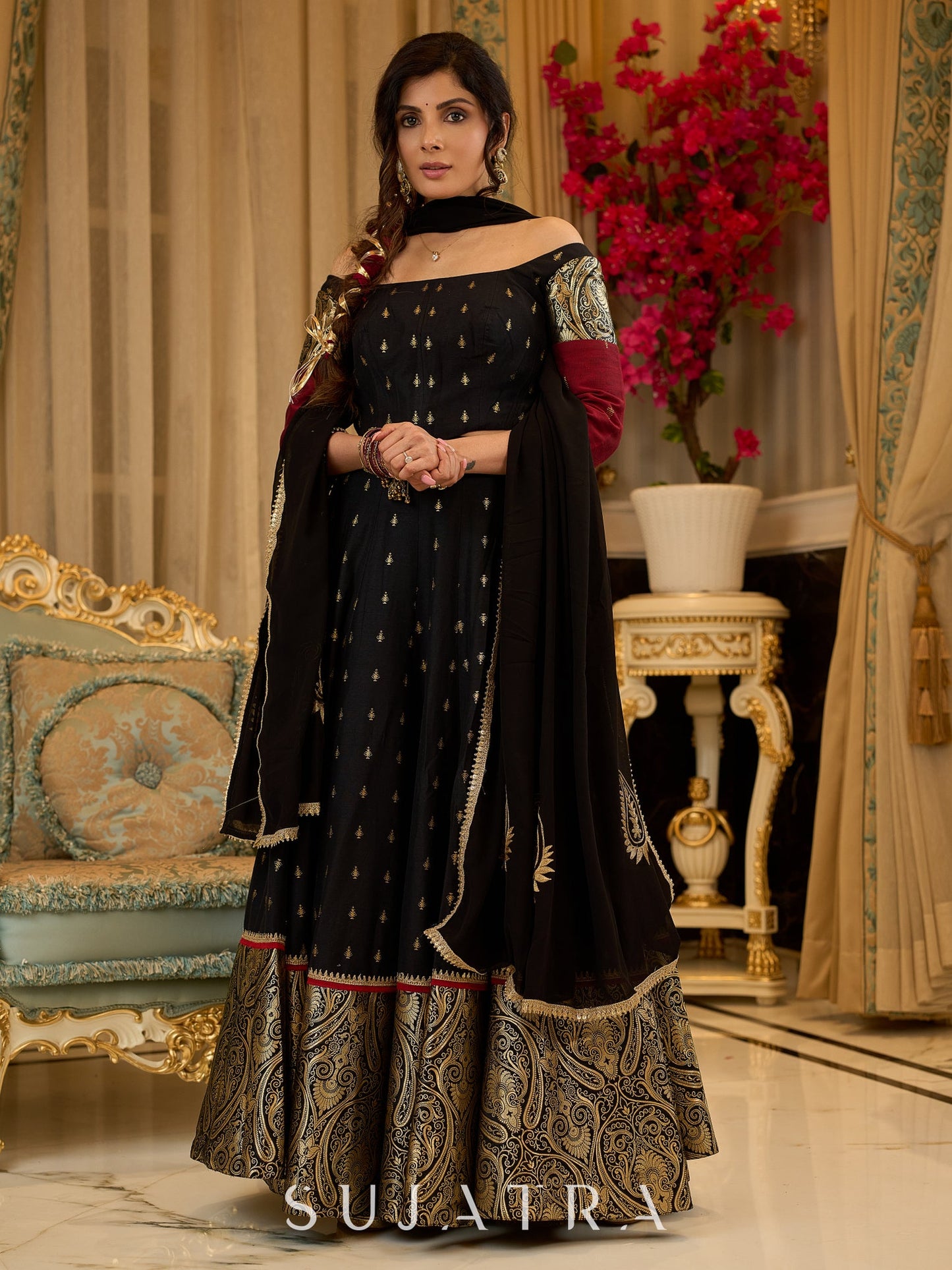 Black cotton silk & brocade lehenga paired with a sculpted corset style choli featuring intricate stonework on sleeves .