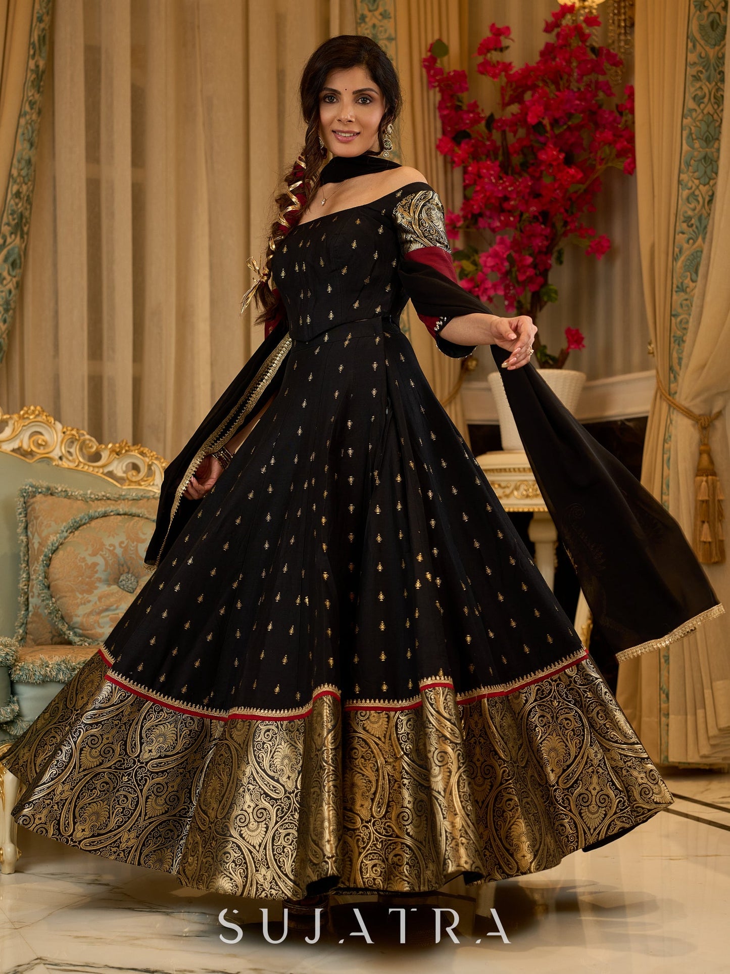 Black cotton silk & brocade lehenga paired with a sculpted corset style choli featuring intricate stonework on sleeves .