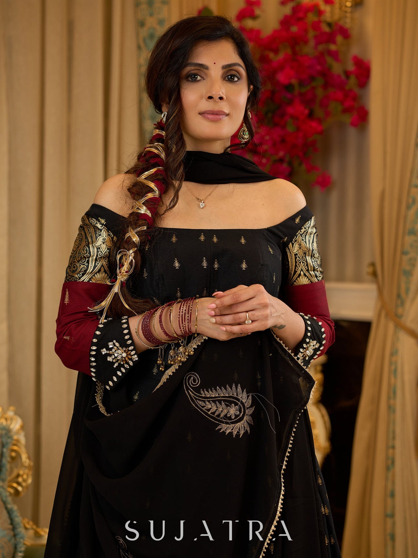 Black cotton silk & brocade lehenga paired with a sculpted corset style choli featuring intricate stonework on sleeves .