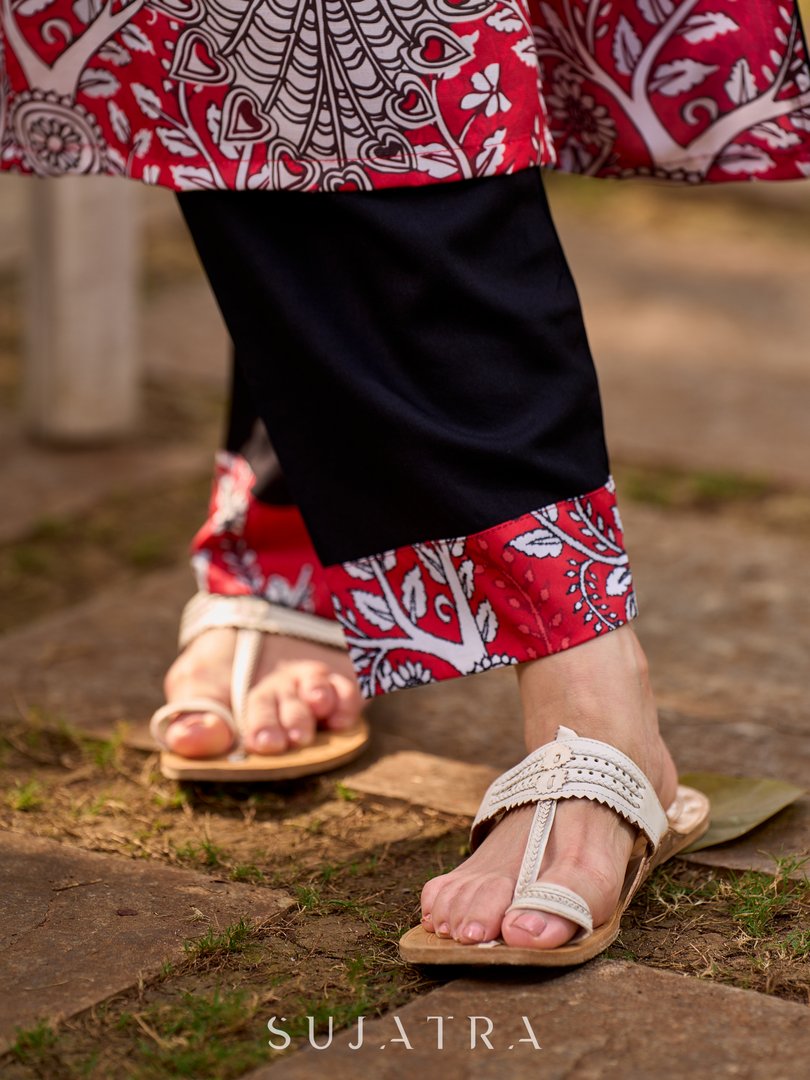 Artisanal red kurta adorned with a Kalamkari peacock motif and a striking asymmetrical neck detail