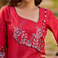 Artisanal red kurta adorned with a Kalamkari peacock motif and a striking asymmetrical neck detail