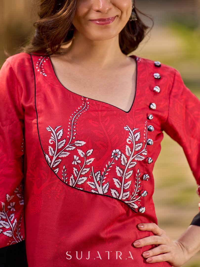 Artisanal red kurta adorned with a Kalamkari peacock motif and a striking asymmetrical neck detail