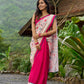 Floral-inspired white saree elevated with fuchsia pleats and borders
