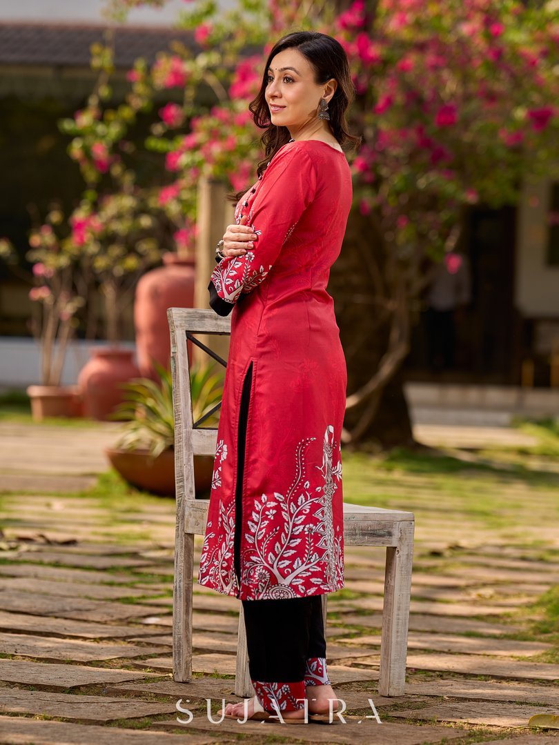 Artisanal red kurta adorned with a Kalamkari peacock motif and a striking asymmetrical neck detail