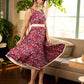 Red Gulmohar floral-printed sleeveless summer dress featuring off-white accents and scalloped lace detailing at the waist, creating a breezy, feminine silhouette perfect for warm, sunlit days.