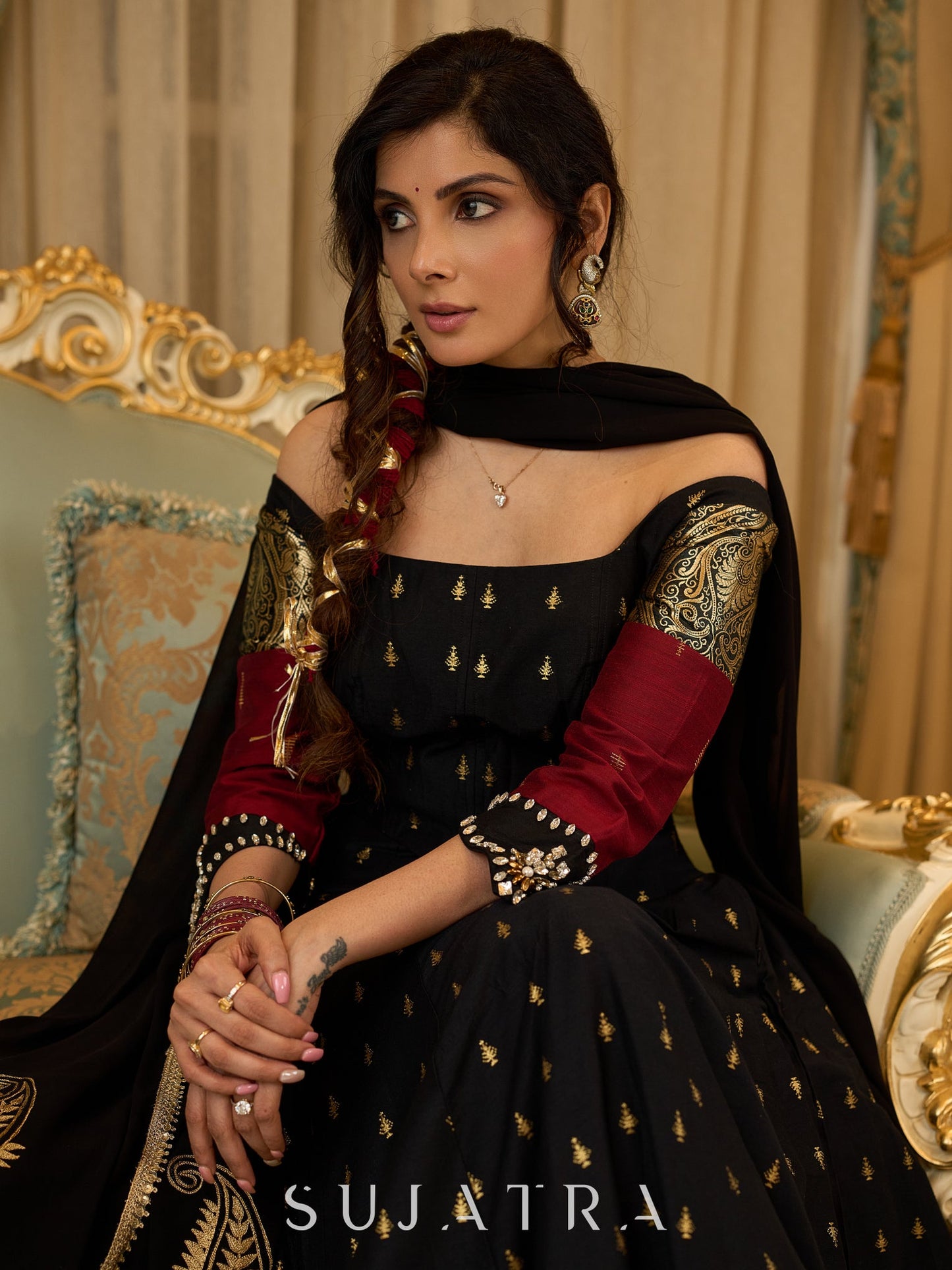Black cotton silk & brocade lehenga paired with a sculpted corset style choli featuring intricate stonework on sleeves .