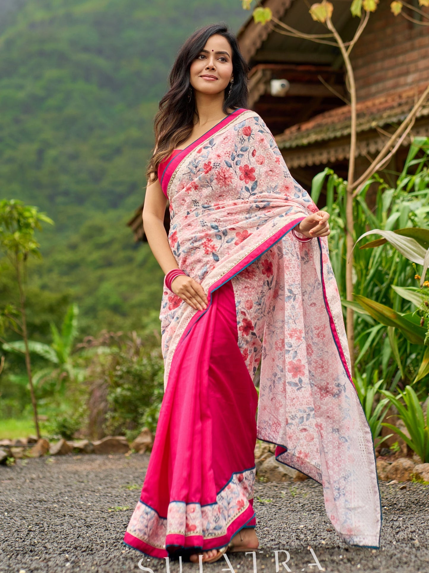 Floral-inspired white saree elevated with fuchsia pleats and borders