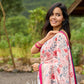 Floral-inspired white saree elevated with fuchsia pleats and borders