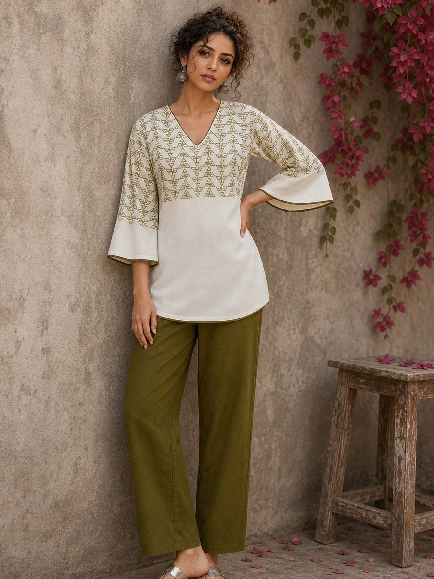 Contemporary off white and olive hand block print top features subtle geometric motifs, airy bell sleeves, and effortless elegance for versatile everyday styling.