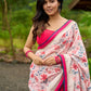 Floral-inspired white saree elevated with fuchsia pleats and borders