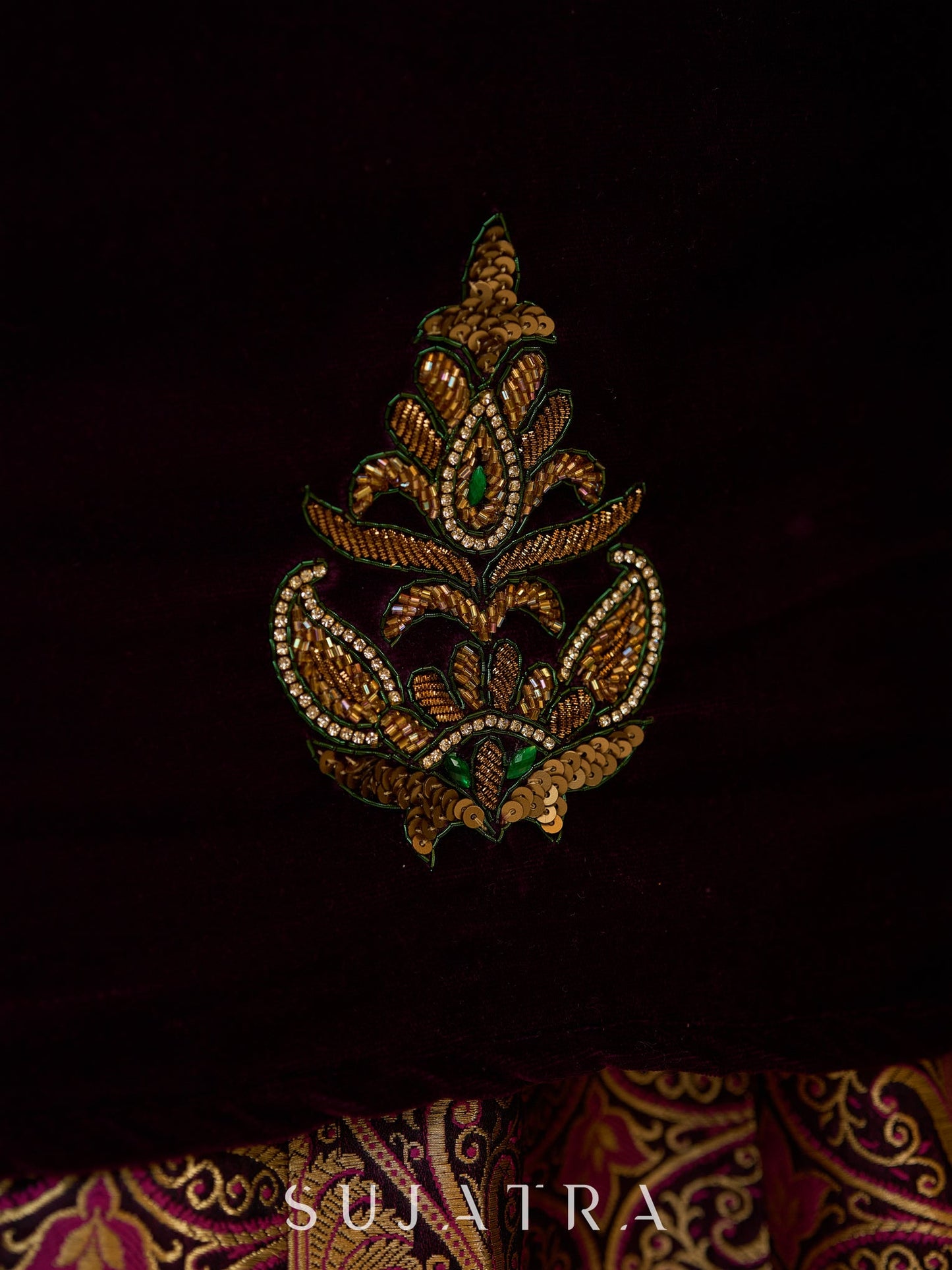 Royal Wine Lehenga with a scalloped hem and a luxurious velvet choli with Zardosi work .