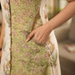 Jaipur-printed sleeveless dress featuring a half-and-half butta and jaal combination, designed with an overlapping silhouette, soft drop shoulders, and wooden accents for an artisanal, contemporary look.