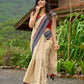 Beige cotton saree enriched with traditional Ikat border and Jamdani accents