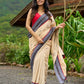 Beige cotton saree enriched with traditional Ikat border and Jamdani accents