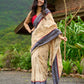 Beige cotton saree enriched with traditional Ikat border and Jamdani accents