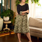 Olive floral dress featuring a contrasting black yoke, designed in a straight fit and highlighted with subtle floral accents for a clean, elegant earthy look