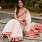 Ivory elegance with royal red Banarasi border, timeless festive glamour
