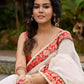 Ivory elegance with royal red Banarasi border, timeless festive glamour