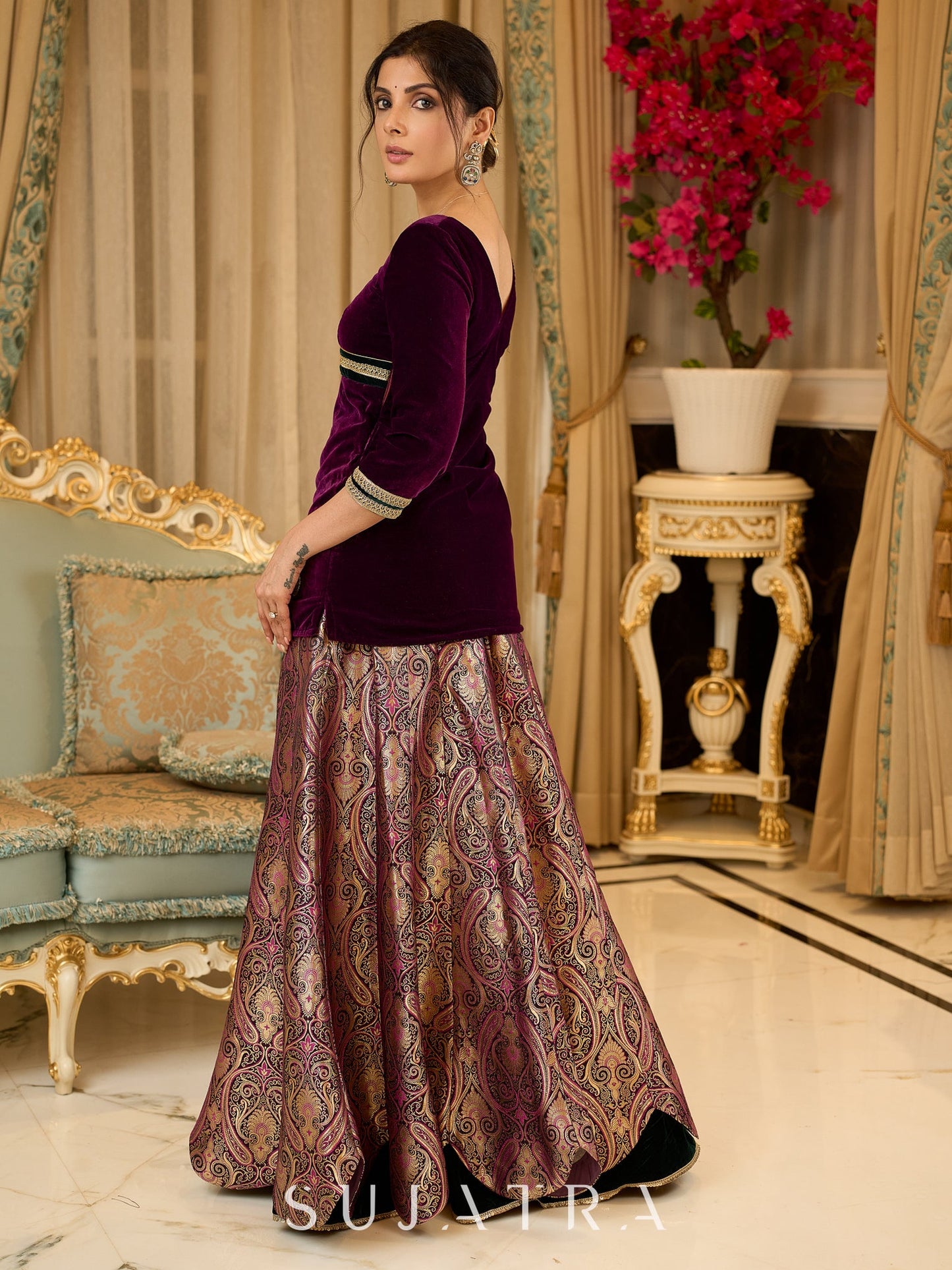Royal Wine Lehenga with a scalloped hem and a luxurious velvet choli with Zardosi work .