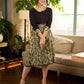 Olive floral dress featuring a contrasting black yoke, designed in a straight fit and highlighted with subtle floral accents for a clean, elegant earthy look