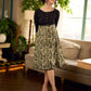 Olive floral dress featuring a contrasting black yoke, designed in a straight fit and highlighted with subtle floral accents for a clean, elegant earthy look