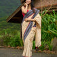 Beige cotton saree enriched with traditional Ikat border and Jamdani accents