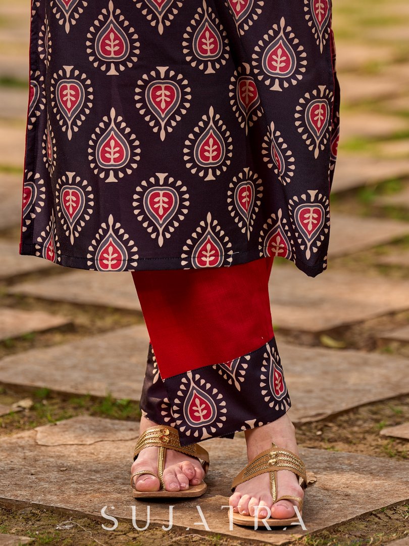 Statement black kurta with Kalamkari-inspired ombré prints and vibrant red touches.
