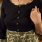 Olive floral dress featuring a contrasting black yoke, designed in a straight fit and highlighted with subtle floral accents for a clean, elegant earthy look