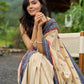 Beige cotton saree enriched with traditional Ikat border and Jamdani accents