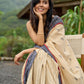 Beige cotton saree enriched with traditional Ikat border and Jamdani accents