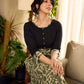 Olive floral dress featuring a contrasting black yoke, designed in a straight fit and highlighted with subtle floral accents for a clean, elegant earthy look