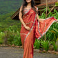 Luxury burnt orange tissue saree adorned with shimmering zari highlights