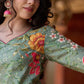 Soft green printed kurta with vibrant floral motifs, highlighted with hand embroidery and bright magenta accents.
