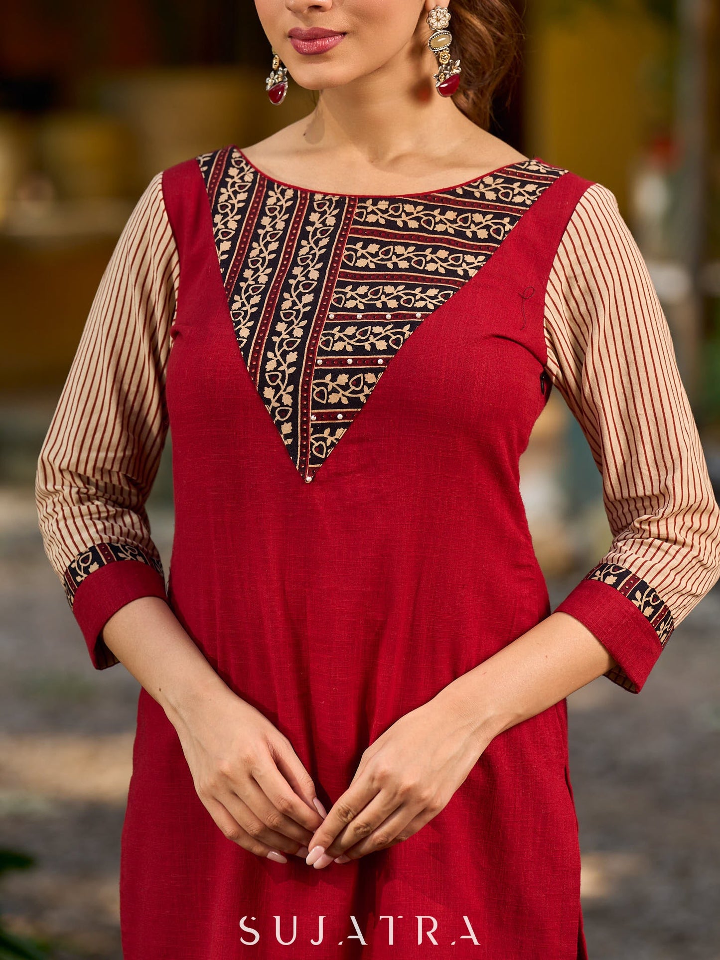 Handcrafted maroon kurta with a V-neck Ajrakh panel and stylish striped sleeves.