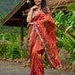 Luxury burnt orange tissue saree adorned with shimmering zari highlights