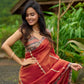 Luxury burnt orange tissue saree adorned with shimmering zari highlights
