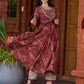 Exquisite deep maroon printed kurta with a graceful bias silhouette, intricate handwork on the yoke, and scalloped sleeve detailing.