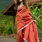 Luxury burnt orange tissue saree adorned with shimmering zari highlights