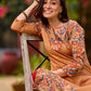 Elegant mustard kurta featuring Kalamkari print in an asymmetrical layout