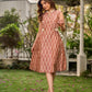 Chic champagne beige Ikat dress elevated with Hakoba accents, a relaxed drop-shoulder fit, mandarin neckline, and fluid side gathers detailed with Hakoba flaps.