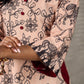 Beige traditional printed dress with rich maroon accents.