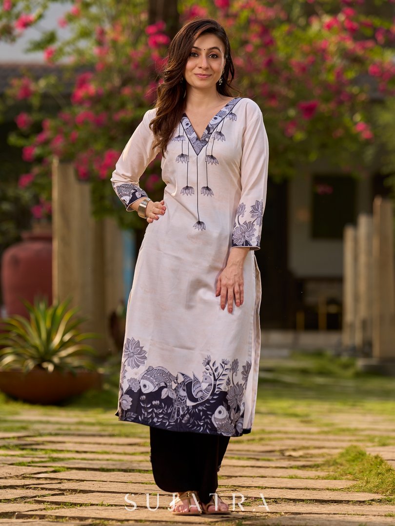 Artisanal cream kurta showcasing Madhubani fish and peacock motifs enhanced with bold black accents